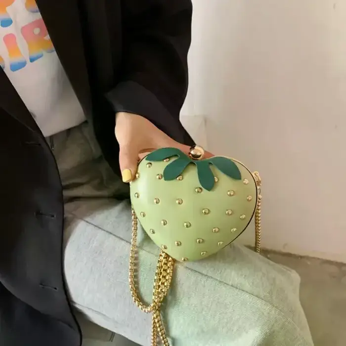 Sac bandoulière rouge en cuir motif fraise avec clous dorés et chaîne