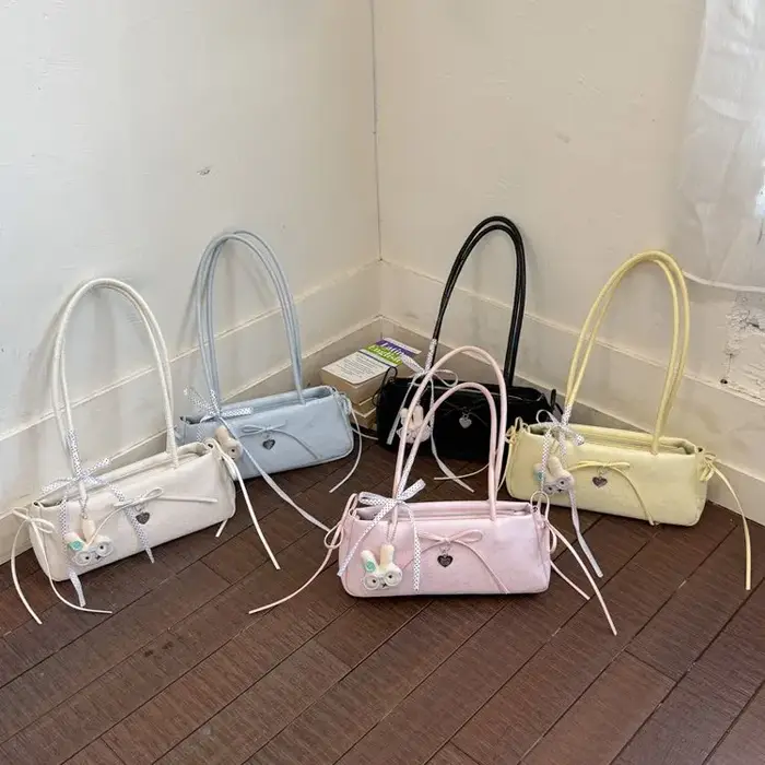 Sac à bandoulière long pour femme avec nœud à pois et breloque cœur