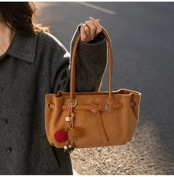 Sac à bandoulière en daim marron pour femme avec pompon décoratif